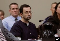 FILE - Larry Nassar sits during his sentencing hearing in Lansing, Michigan.