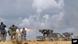 National Transitional Council fighters fire a rocket during clashes with pro-Gadhafi forces at the frontline in Sirte, Libya, October 11, 2011.