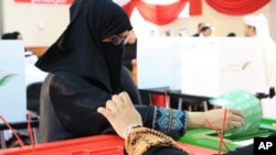 A Bahraini woman votes for parliamentary election, 23 Oct 2010