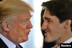 FILE - Canadian Prime Minister Justin Trudeau is greeted by U.S. President Donald Trump prior to holdiing talks at the White House in Washington, Feb. 13, 2017.