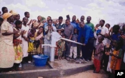 Villagers mark the opening of a new borehole