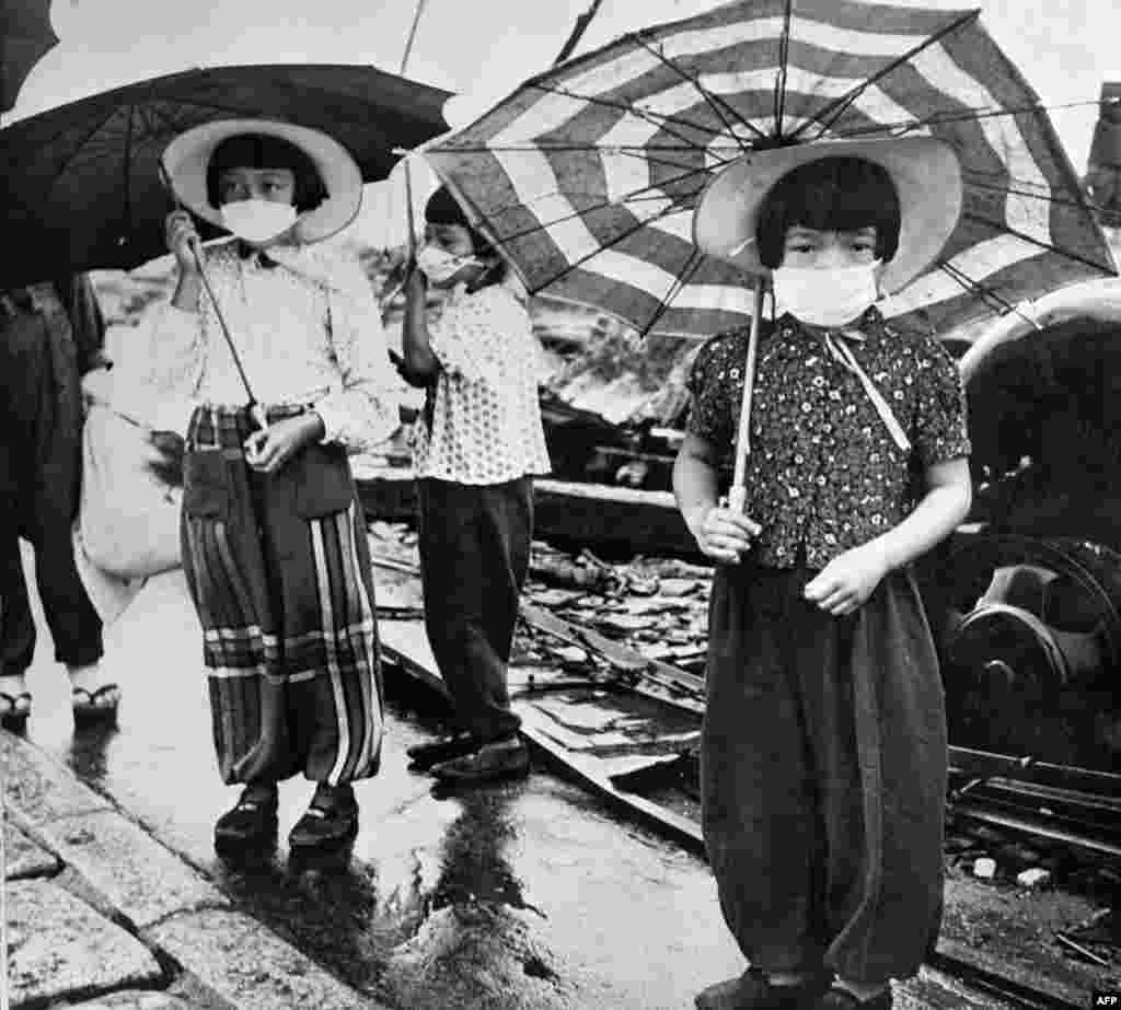 Picture dated 1948 showing children wearing masks to protect themselves from irradiation in the devastated city of Hiroshima after the US nuclear bombing on August 6, 1945.