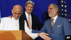 Afghan presidential candidate Abdullah Abdullah, from right, U.S. Secretary of State John Kerry and Afghan presidential candidate Ashraf Ghani Ahmadzai share a light moment at the podium during a joint press conference in Kabul, Afghanistan, Aug. 8, 2014.