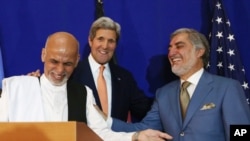 Afghan presidential candidate Abdullah Abdullah, from right, U.S. Secretary of State John Kerry and Afghan presidential candidate Ashraf Ghani Ahmadzai share a light moment at the podium during a joint press conference in Kabul, Afghanistan, Aug. 8, 2014.
