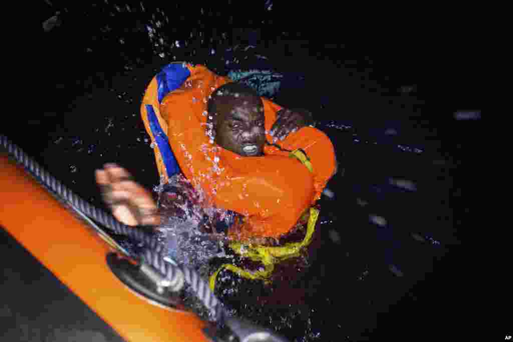 A migrant swims frantically toward a rescue ship in the Mediterannean Sea off the coast of Libya.