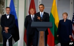 President Barack Obama, center, accompanied by the leaders of Baltic States, from left, Estonia President Toomas Hendrik Ilves, Latvia President Andris Berzins and Lithuanian President Dalia Grybauskaite, speaks after their meeting at Kadriorg Art Museum