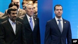 Front row from left, Iranian President Ahmadinejad, Kazakhstan's President Nazarbayev and Russian President Medvedev walk after a meeting of the Shanghai Cooperation Organization in Kazakhstan's capital Astana, June 15, 2011