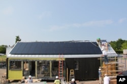 Professional builders worked with students to construct the solar-powered house.