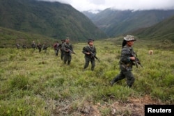 Members of the 51st Front of the Revolutionary Armed Forces of Colombia (FARC) patrol in the remote mountains of Colombia, Aug. 16, 2016.
