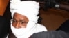 FILE - Security personnel surround former Chadian dictator Hissene Habre inside a courtroom in Dakar, Senegal, July 20, 2015.