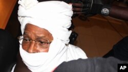 FILE - Security personnel surround former Chadian dictator Hissene Habre inside a courtroom in Dakar, Senegal, July 20, 2015.