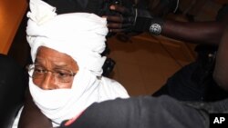 FILE - Security personnel surround former Chadian dictator Hissene Habre inside the court, in Dakar, Senegal, July 20, 2015. 
