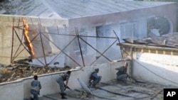 Afghan police fight suicide attackers who took over a guesthouse and killed four Afghan security guards in Kunduz province, Afghanistan, August 2, 2011.