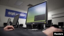 U.S. Marine Sergeant Michael Kidd works on a computer at ECPI University in Virginia Beach, Virginia, February 7, 2012.