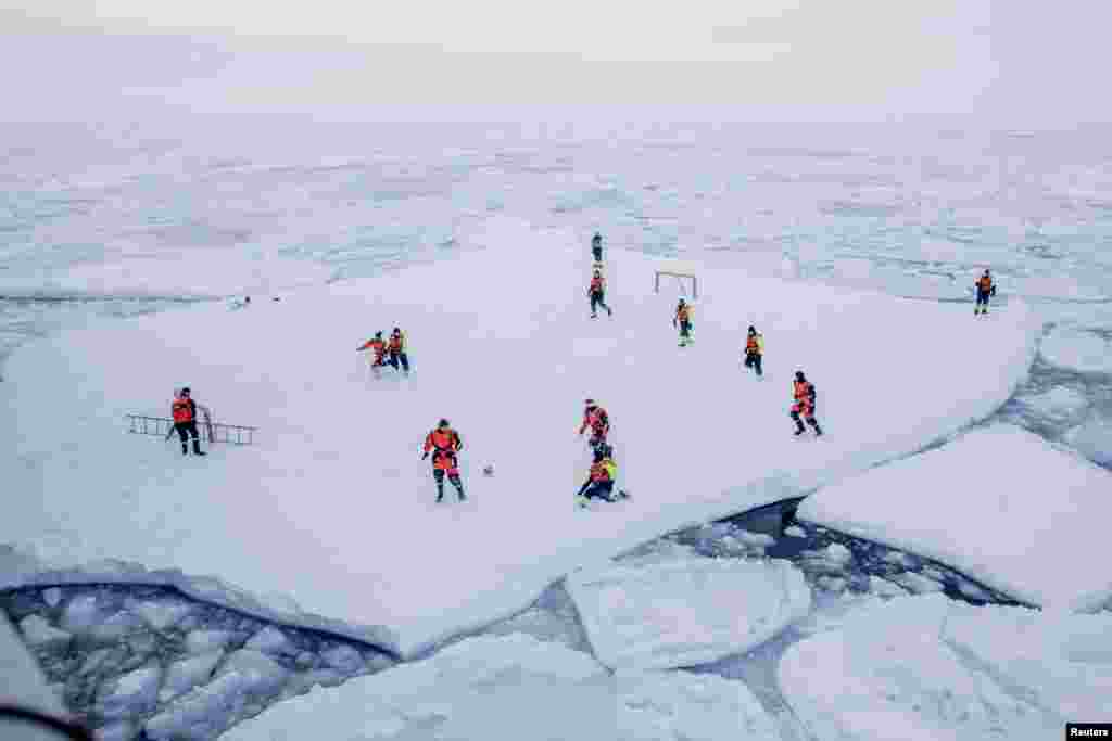 KV Svalbard&#39;s crew, formed by Norwegian Navy privates and scientists from Norwegian Institute of Marine Research, play soccer in the arctic environment in the sea around Greenland.