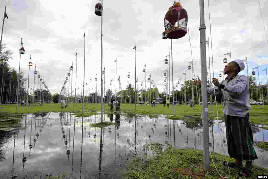 Villagers prepare their birds in cages for a bird-singing contest in Yala province, 1,100 km (684 miles) south of Bangkok, Thailand.