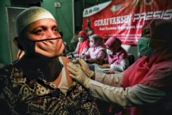 Seorang pria disuntik vaksin COVID-19 Sinovac di desa Pusong, Lhokseumawe, Aceh, 8 Juli 2021. (Foto: AZWAR IPANK / AFP)