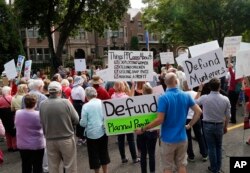 Hundreds of demonstrators gather outside the governor's mansion in St. Paul, Minn., Sept. 9, 2015, in a protest calling for Governor Mark Dayton to defund and investigate Planned Parenthood.