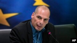 FILE - Greek Finance Minister Yanis Varoufakis answers a reporter's question during a joint news conference with Eurogroup President Jeroen Dijsselbloem, following their meeting at the Finance Ministry in Athens, Jan. 30, 2015. 