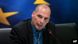 Greek Finance Minister Yanis Varoufakis answers a reporter's question during a joint news conference with Eurogroup President Jeroen Dijsselbloem, following their meeting at the Finance Ministry in Athens, Jan. 30, 2015. 
