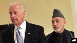 Afghanistan's president Hamid Karzai (R) and US Vice President Joe Biden (L) arrive for a press conference at the Presidential palace in Kabul on 11 Jan, 2011.