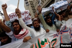 FILE - Supporters of the Jamaat-ud-Dawa organisation chant slogans during a protest rally in Karachi, June 27, 2014.