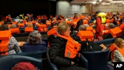 This photo provided by Michal Stewart shows passengers on board the Viking Sky, waiting to be evacuated, off the coast of Norway, March 23, 2019.