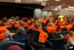 This photo provided by Michal Stewart shows passengers on board the Viking Sky, waiting to be evacuated, off the coast of Norway, March 23, 2019.