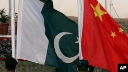 FILE - Flags of Pakistan and China fly during a joint anti-terrorism military exercises in Abbottabad, Pakistan, Dec. 11, 2006.