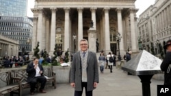 In this photo taken Nov. 2, 2017, Hubertus Vaeth, the managing director of Frankfurt Main Finance poses for a portrait outside the Royal Exchange in the City of London. With London-based banks, insurers and asset managers all scrambling to prepare for Britain's exit from the European Union, Hubertus Vaeth is putting out Frankfurt's welcome mat for any financial service refugees who are looking for an EU base after Brexit in March 2019. 