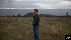 FILE - Jim Buterbaugh, a vocal opponent of refugees coming to his state, stands on ranch land belonging to a friend near Clearwater, Mont., on April 12, 2016. 
