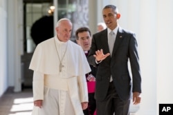 President Barack Obama and Pope Francis, accompanied by Msgr. Mark Miles, the English translator for the Pontiff, walk down the Colonnade before meeting in the Oval Office of the White House in Washington, Sept. 23, 2015