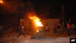 Protesters burn tires in a street after Senegal's highest court ruled that the country's increasingly frail President Abdoulaye Wade, 85, could run for a third term in next month's presidential election, in Dakar, Senegal, January 27, 2012.