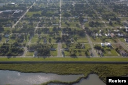 FILE - Empty lots are seen scattered throughout the Lower Ninth Ward neighborhood of New Orleans, Louisiana, Aug. 25, 2015.