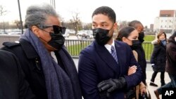 Actor Jussie Smollett looks back at his mother as they arrive with other family members, at the Leighton Criminal Courthouse for jury selection at his trial in Chicago, Nov. 29, 2021. 