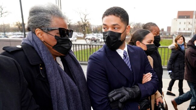 Actor Jussie Smollett looks back at his mother as they arrive with other family members, at the Leighton Criminal Courthouse for jury selection at his trial in Chicago, Nov. 29, 2021.