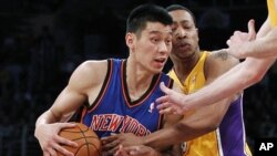 Newly-acquired New York Knicks guard Jeremy Lin (L) is fouled by Los Angeles Lakers' Andrew Goudelock (R) during second half of an NBA basketball game in Los Angeles December 29, 2011.