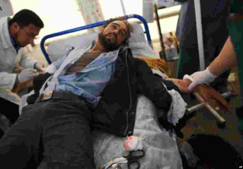 A wounded rebel receives medical treatment at the Al-Hikma hospital in the besieged city of Misrata, April 23, 2011. Misrata has been the scene of deadly urban guerrilla fighting between pro-Gadhafi forces and outgunned rebels for more than six weeks. (A