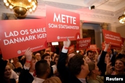 FILE - Supporters of Danish Social Democrats celebrate in the parliament in Copenhagen, Denmark, June 5, 2019.