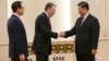 FILE - U.S. Trade Representative Robert Lighthizer, center, shakes hands with Chinese President Xi Jinping next to U.S. Treasury Secretary Steven Mnuchin, left, before their meeting at the Great Hall of the People in Beijing.