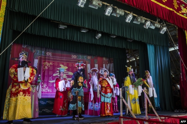 Chiu Chow Opera performers sing on stage as part of the Hungry Ghost Festival in Hong Kong on September 4, 2018.