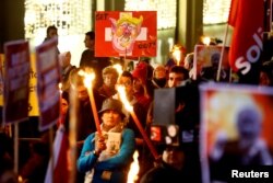 Demonstrators rally to protest U.S. President Donald Trump's attendance of the Davos World Economic Forum, in Geneva, Switzerland, Jan. 23, 2018.