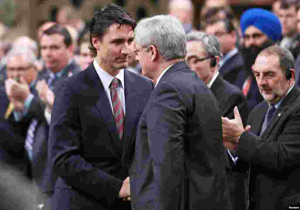 Prime Minister Stephen Harper, right, shakes hands with Liberal Leader Justin Trudeau in the House of Commons in Ottawa, Oct. 23, 2014.