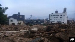 Debris fills a small village following heavy rains Sunday, July 8, 2018, in Kuchita-Minami, Asakita-ku, Hiroshima, Japan. (AP Photo Haruka Nuga)