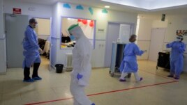 Health worker wearing protective suits to protect from coronavirus work at a nursing home, in Madrid, Spain, Tuesday, March 31, 2020.