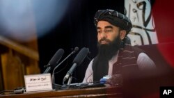 FILE - Taliban government spokesman Zabihullah Mujahid gives a press conference in Kabul, Afghanistan, Sept. 21, 2021. 