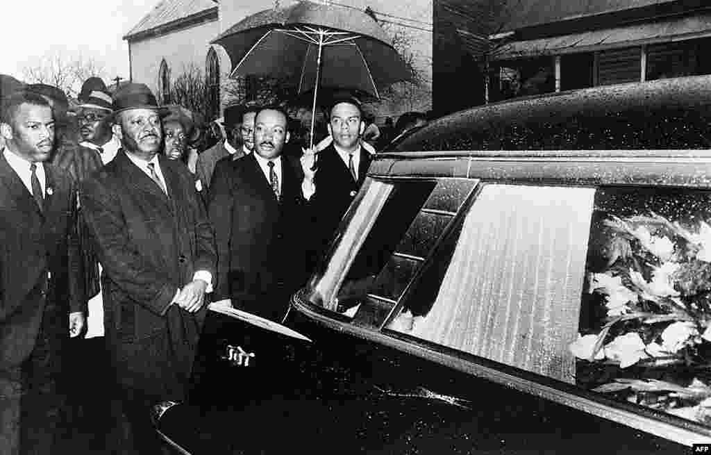 Dr. Martin Luther King, Jr. and associates lead a procession behind the casket of Jimmy Lee Jackson during a funeral service at Marion, Alabama, March 1, 1965. (AP)