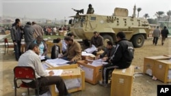 Election officials count ballots for the parliamentary elections in Cairo, Egypt, Nov. 30, 2011