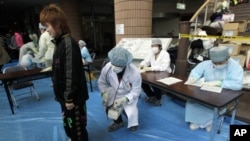 Medical staff screen people who are concerned over radiation exposure in Niigata, northern Japan March 16, 2011.