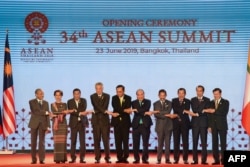 FILE - ASEAN leaders shake hands on stage during the opening ceremony of the 34th ASEAN Summit at the Athenee Hotel in Bangkok, Thailand, June 23, 2019.